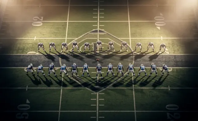 NFL team helmets arranged around a Fantasy Football draft board showing 2026 salary cap figures